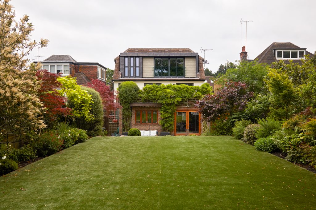Rear garden view of the completed East Finchley family home showing the new dormer roof extension