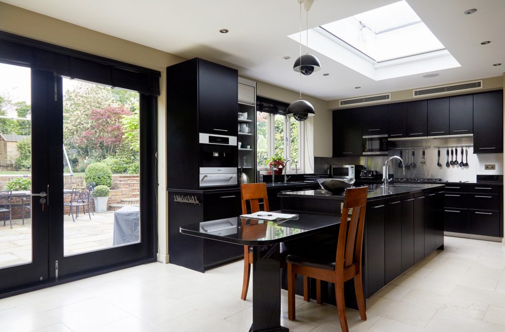 Refurbished open-plan kitchen with skylight and bifold doors to the garden in the East Finchley family home